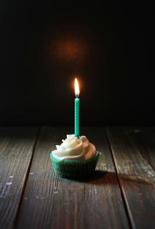 taper candle on cupcake by Angèle Kamp courtesy of Unsplash.