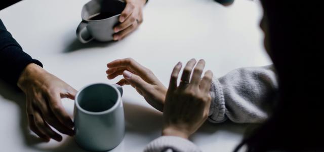 a group of people sitting around a white table by Priscilla Du Preez 🇨🇦 courtesy of Unsplash.